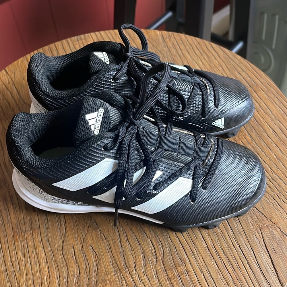 Adidas Adizero black/white cleats size 1. Used. Dog bites on one shoe.
